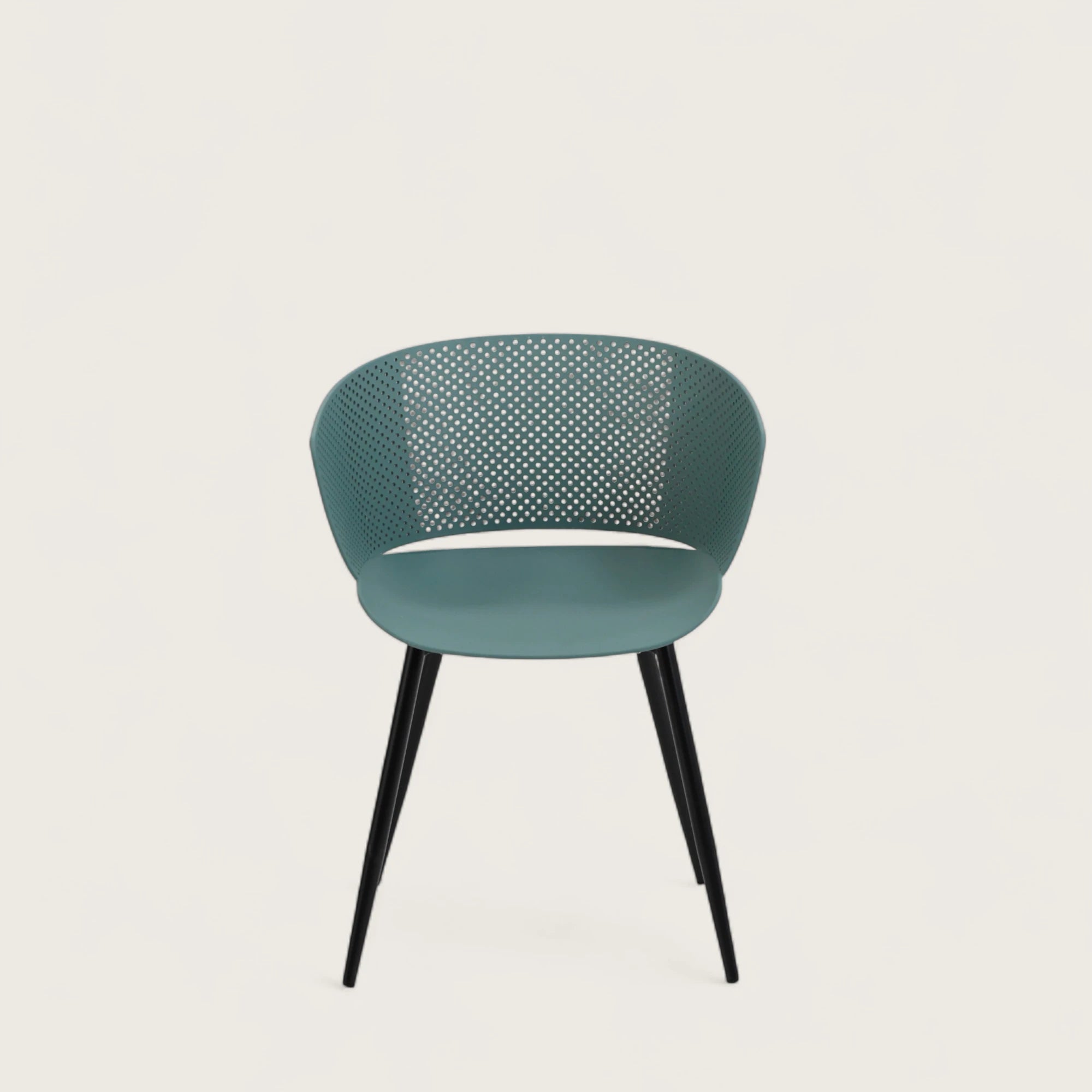 Sedia con scocca in polipropilene colore petrolio, schienale avvolgente e gambe in metallo nero opaco, ideale per sale da pranzo, cucine e spazi contract.