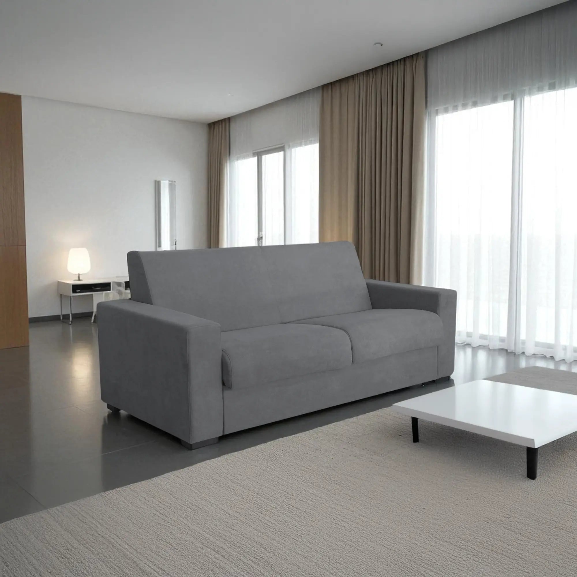 Il divano letto trasformabile in tessuto grigio con materasso integrato. Design moderno, materasso confortevole 140x190 cm e tessuto resistente. Perfetto per ogni ambiente.